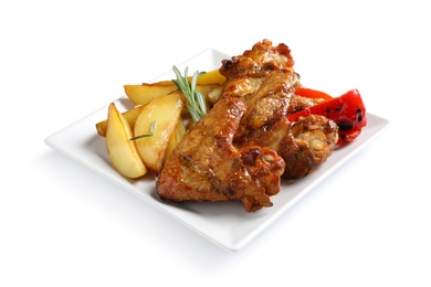 Photo of Plate with barbecued chicken wings and garnish on white background