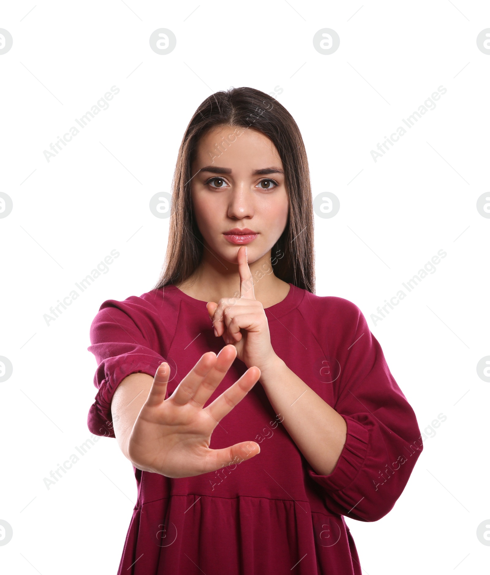 Photo of Woman showing HUSH gesture in sign language on white background