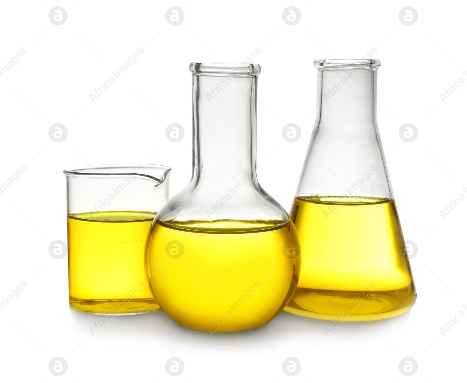 Photo of Laboratory glassware with yellow liquid on white background