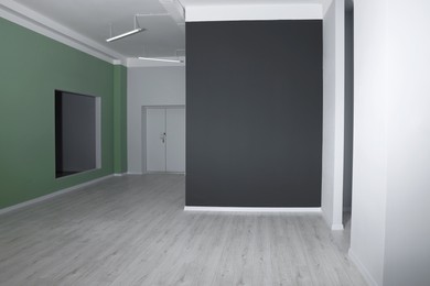 Photo of Empty renovated room with color walls and door