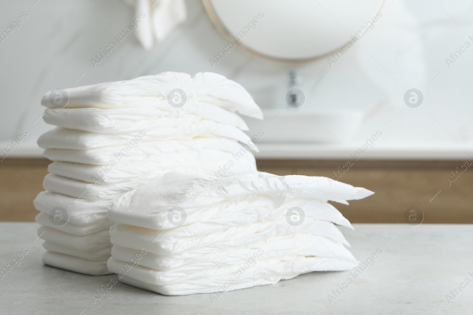 Photo of Stacks of baby diapers on counter in bathroom