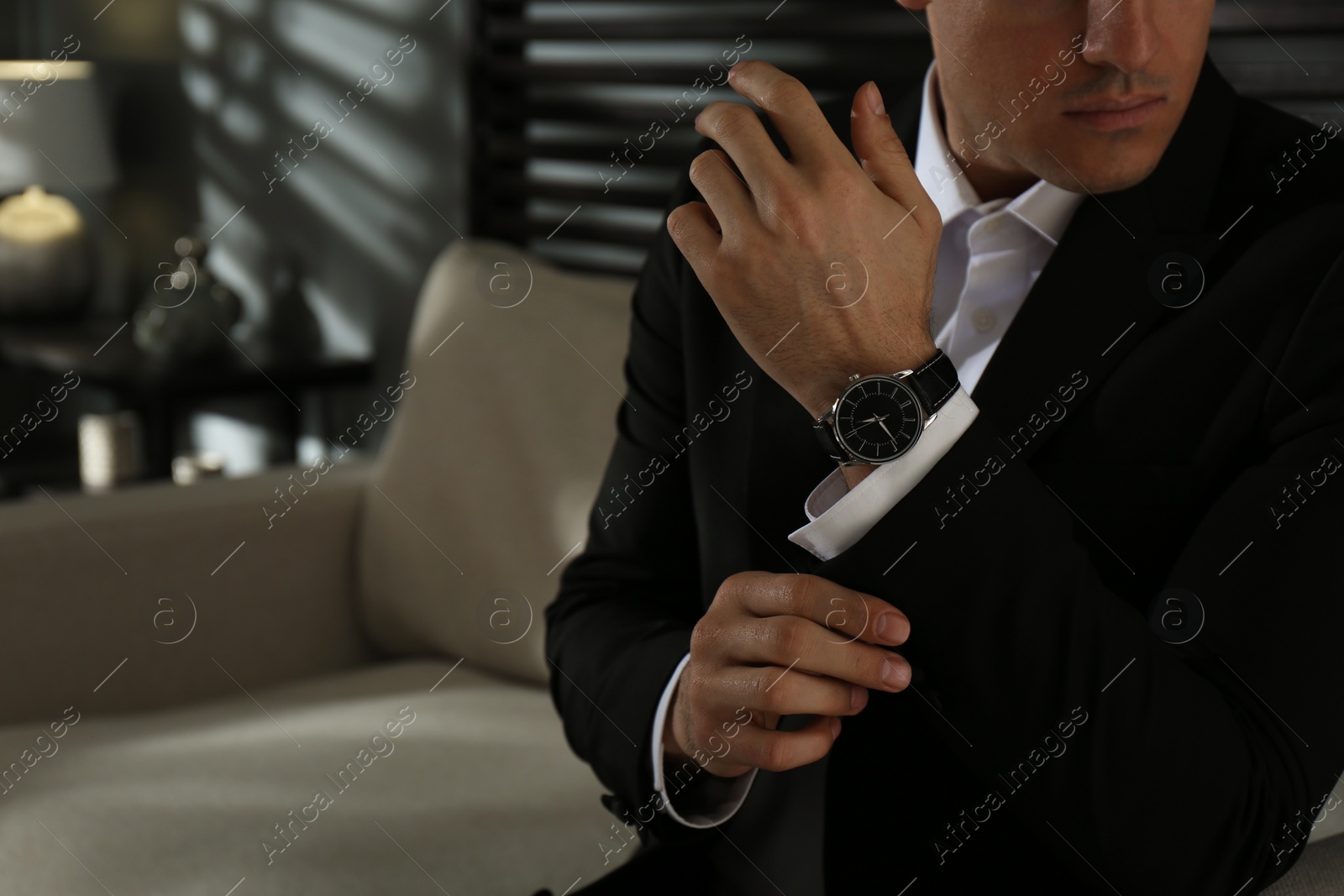 Photo of Businessman with luxury wrist watch indoors, closeup. Space for text