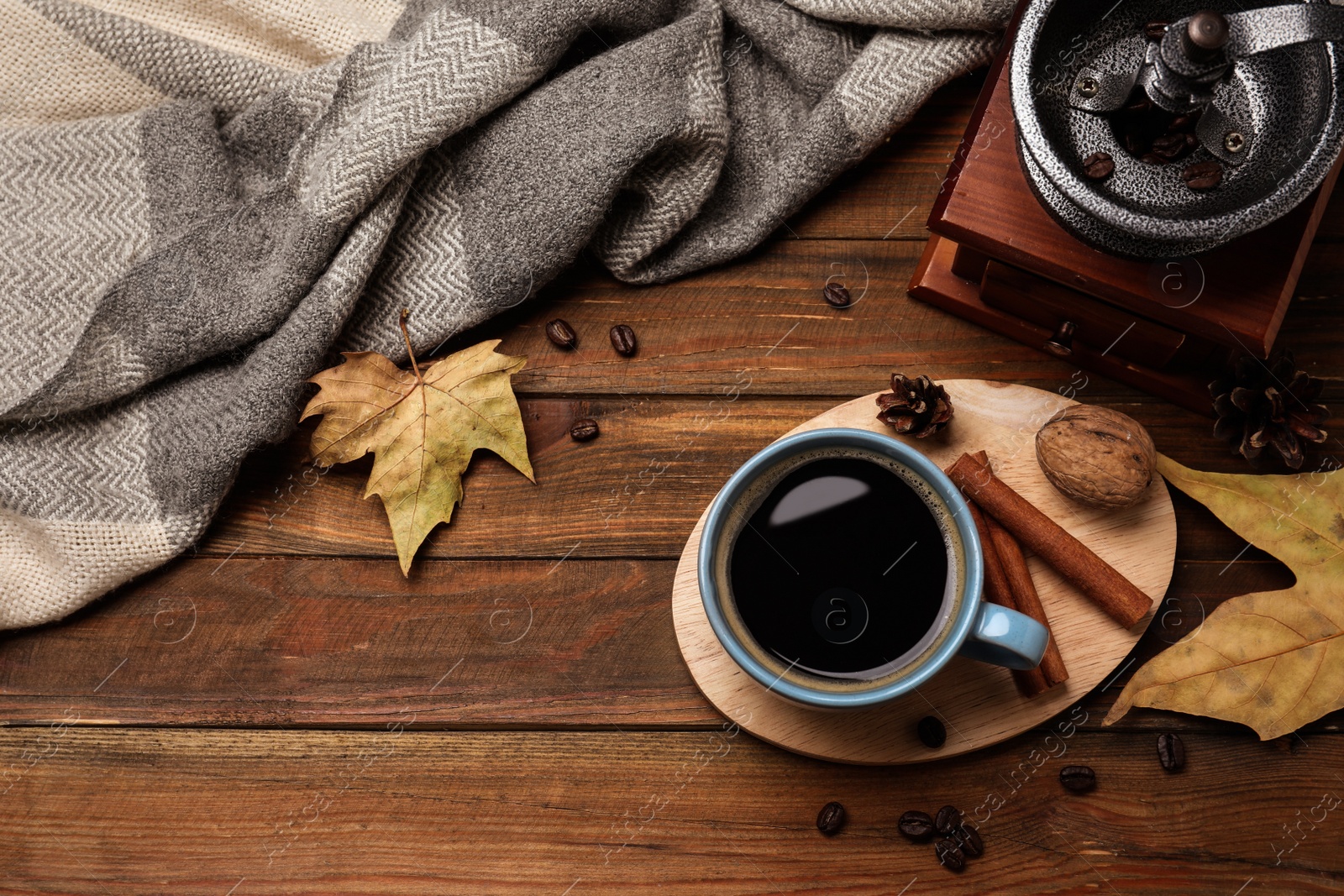 Photo of Flat lay composition with cup of hot drink on wooden table. Cozy autumn atmosphere