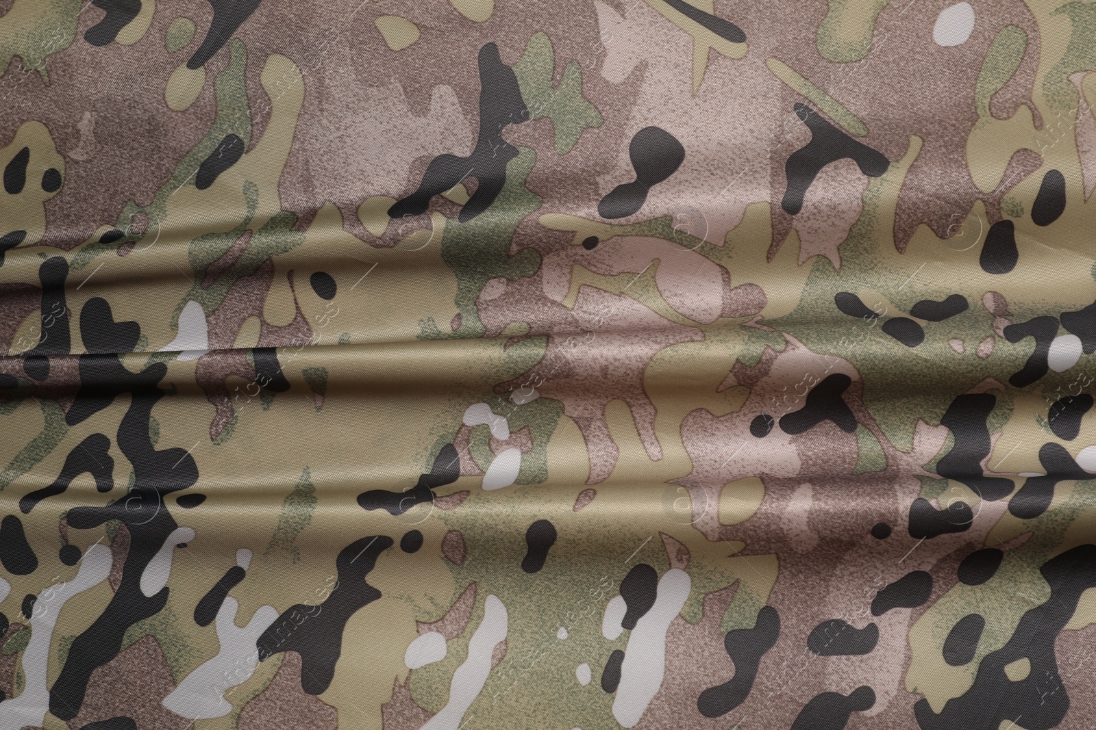 Photo of Texture of crumpled camouflage fabric as background, top view