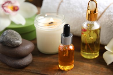 Photo of Composition with spa cosmetic on wooden table, closeup