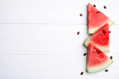 Watermelon slices on white wooden background, flat lay. Space for text