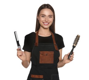 Photo of Portrait of happy hairdresser with brushes on white background