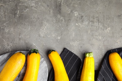 Photo of Flat lay composition with fresh ripe yellow zucchini on grey table, space for text