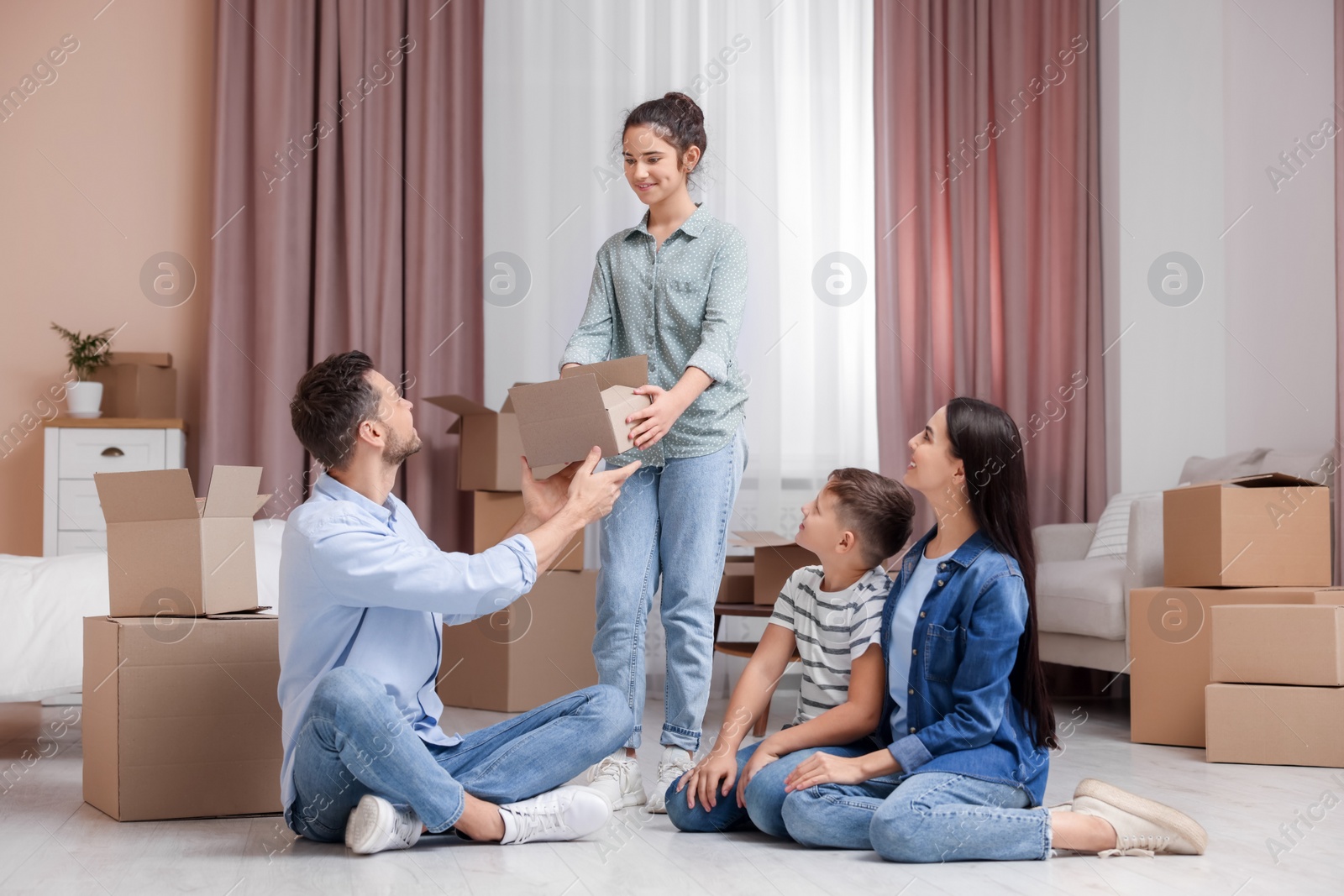 Photo of Happy family settling into new house and unpacking boxes. Moving day