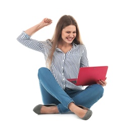 Emotional young woman with laptop celebrating victory on white background