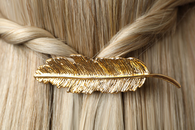 Photo of Woman with beautiful gold hair clip, closeup