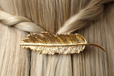 Woman with beautiful gold hair clip, closeup