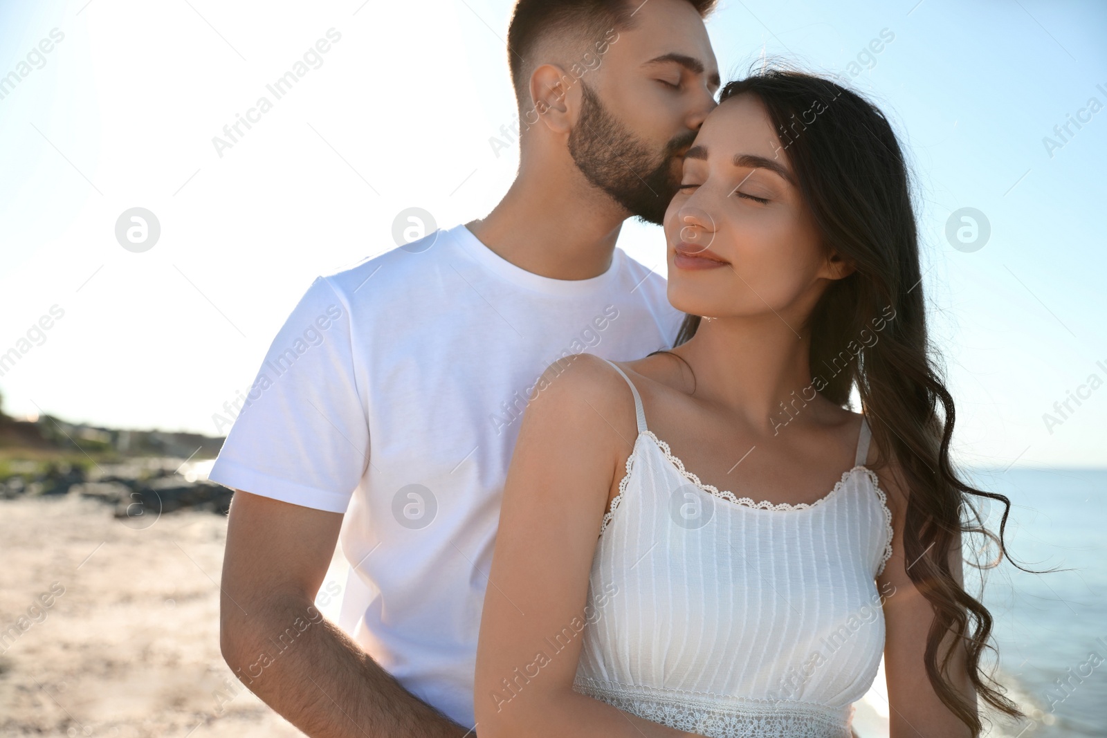 Photo of Happy young couple at beach. Honeymoon trip