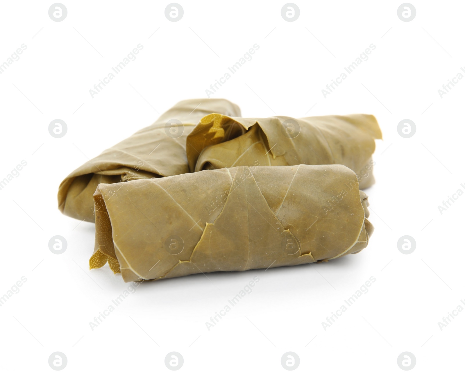 Photo of Delicious stuffed grape leaves on white background