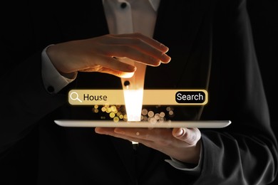 Businesswoman using tablet to find house, closeup. Search bar over device