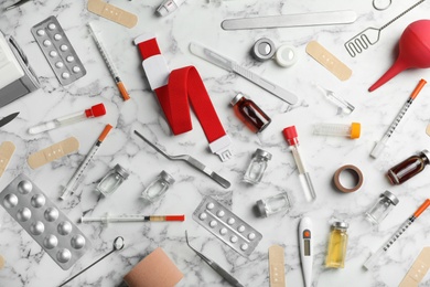 Photo of Many different medical objects on marble background, flat lay