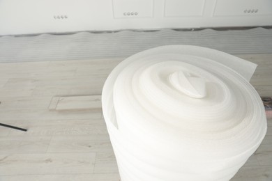 Photo of Roll of polyethylene foam in room prepared for renovation, closeup