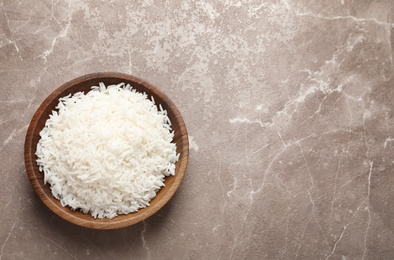 Photo of Plate of tasty cooked rice on color background, top view. Space for text
