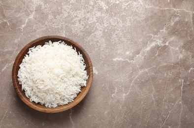 Plate of tasty cooked rice on color background, top view. Space for text