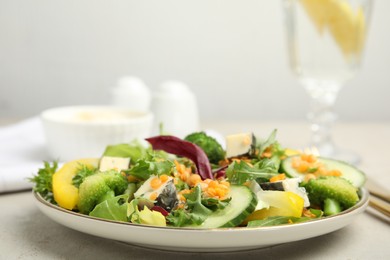 Delicious salad with lentils, vegetables and cheese served on light grey table