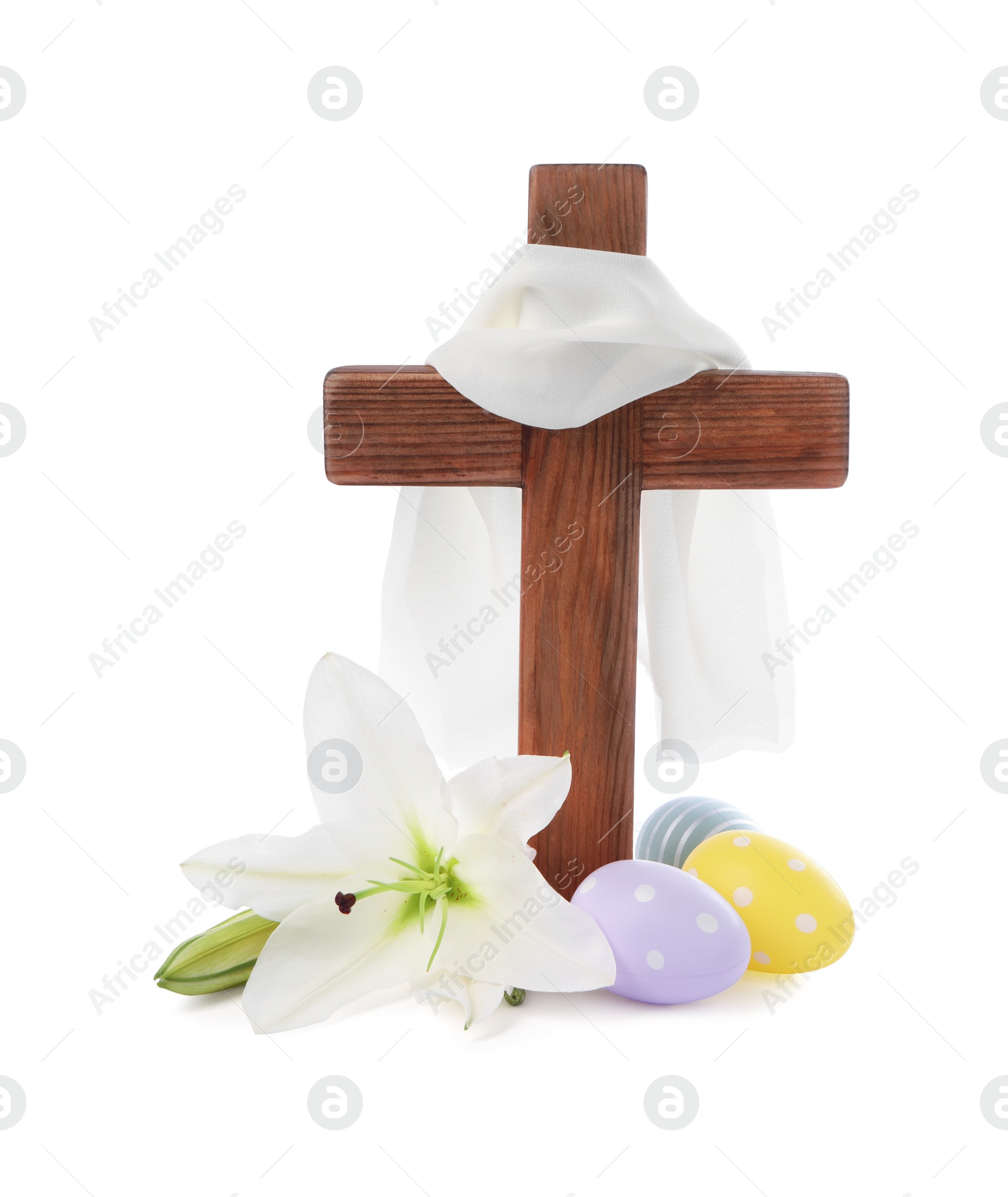 Photo of Wooden cross, cloth, painted Easter eggs and lily flowers on white background