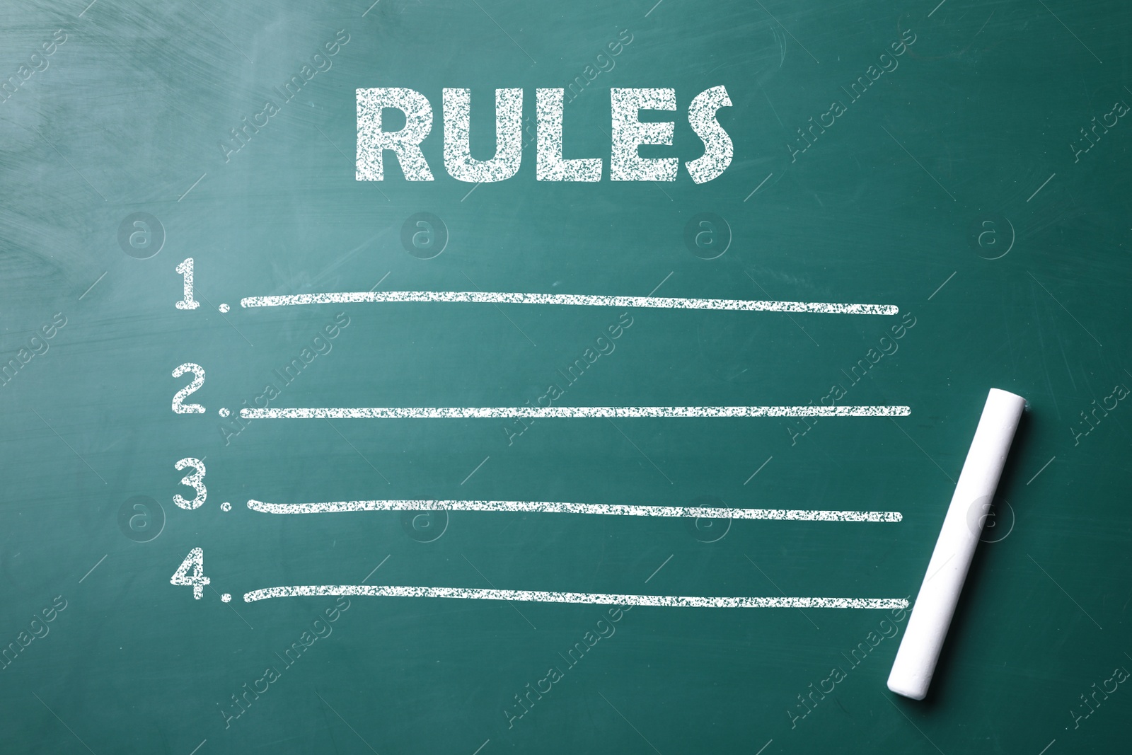 Image of White chalk stick on greenboard and list of rules, top view