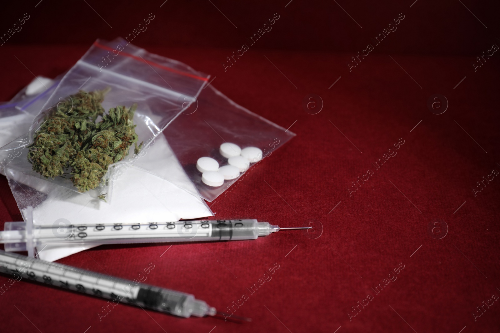 Photo of Cocaine, dried hemp and ecstasy on color background. Space for text