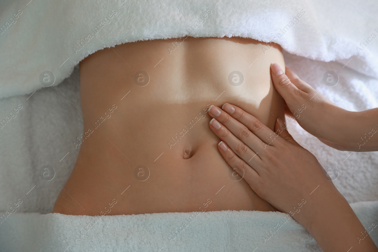 Photo of Woman receiving professional belly massage, closeup view