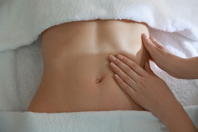 Photo of Woman receiving professional belly massage, closeup view