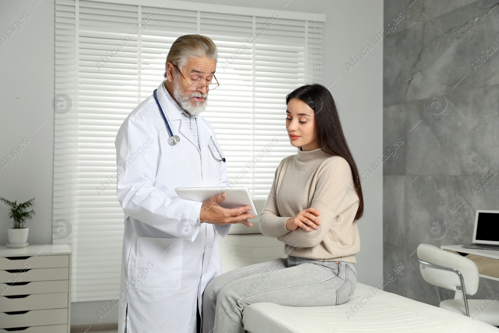 Photo of Patient having appointment with senior doctor in clinic