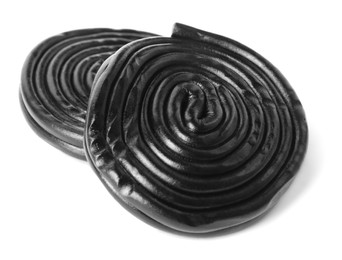 Tasty black liquorice candies on white background