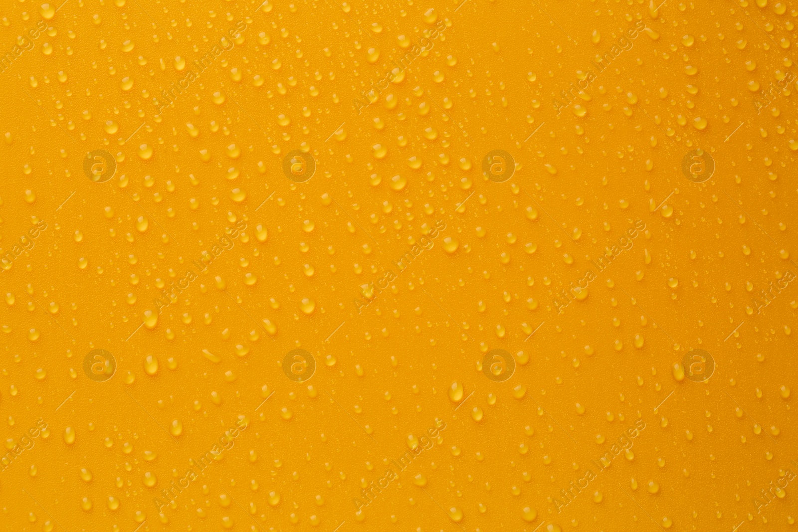 Photo of Water drops on orange background, top view