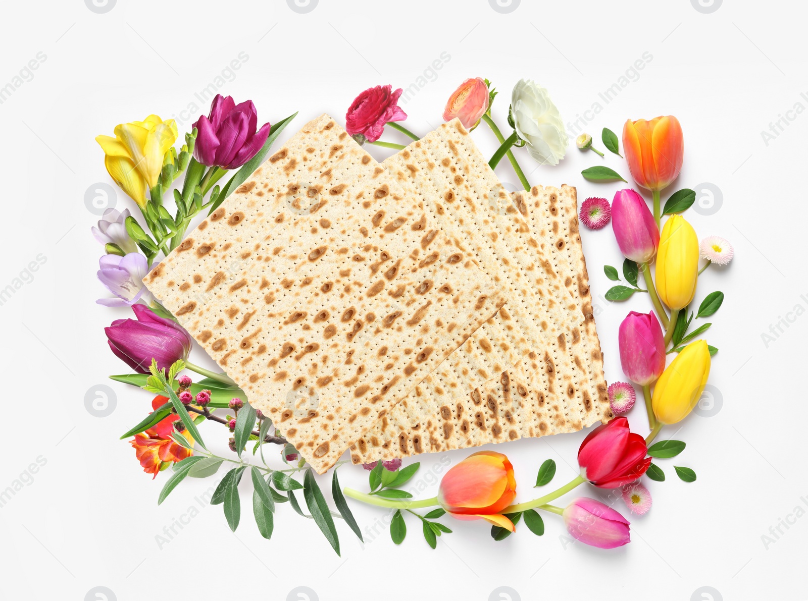 Image of Tasty matzos and flowers on white background, top view. Passover (Pesach) celebration