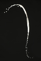 Photo of Splash of fresh milk on black background