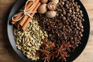 Different spices and nuts on table, top view