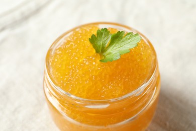 Fresh pike caviar in glass jar on table, closeup