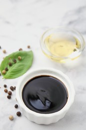 Photo of Bowl with balsamic vinegar on white table