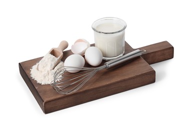 Photo of Board with metal whisk, raw eggs, flour, milk and scoop isolated on white