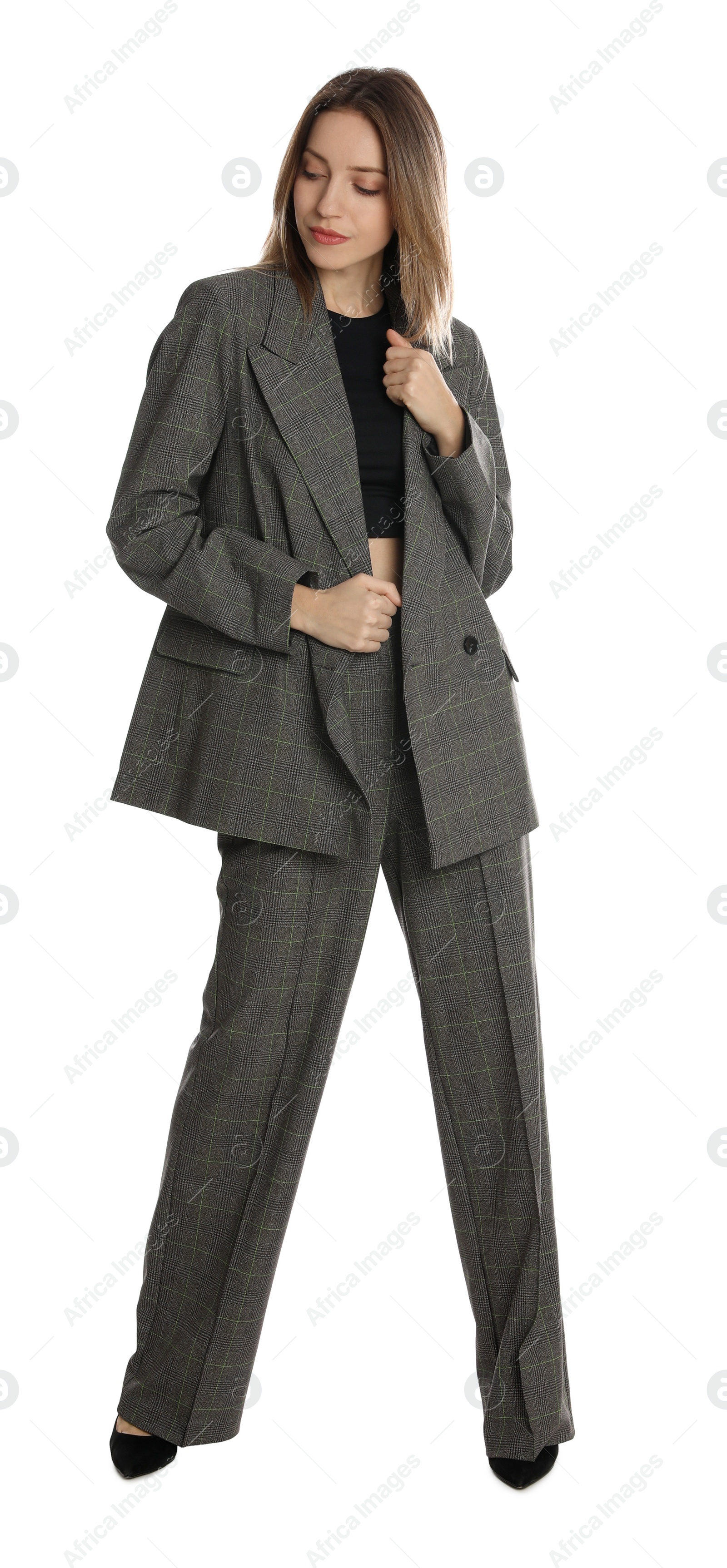 Photo of Full length portrait of beautiful young woman in fashionable suit on white background. Business attire