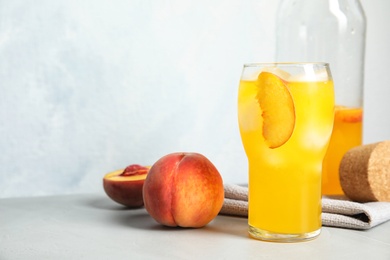 Photo of Tasty peach cocktail on table. Refreshing drink