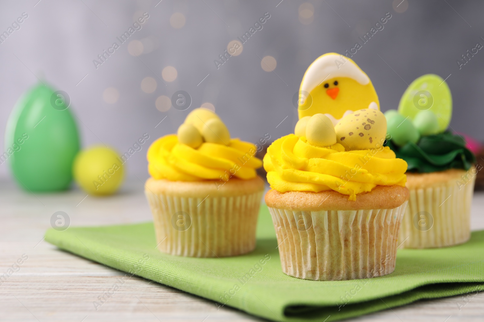 Photo of Tasty decorated Easter cupcakes on wooden table