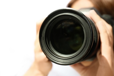 Photo of Female photographer with professional camera on white background