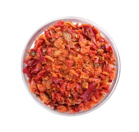 Photo of Aromatic spice. Red chili pepper flakes in bowl isolated on white, top view