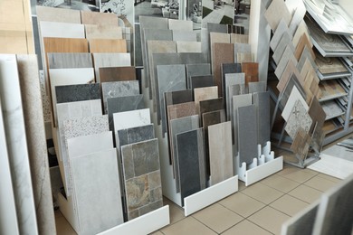 Photo of Assortment of tiles in store. Many different samples indoors