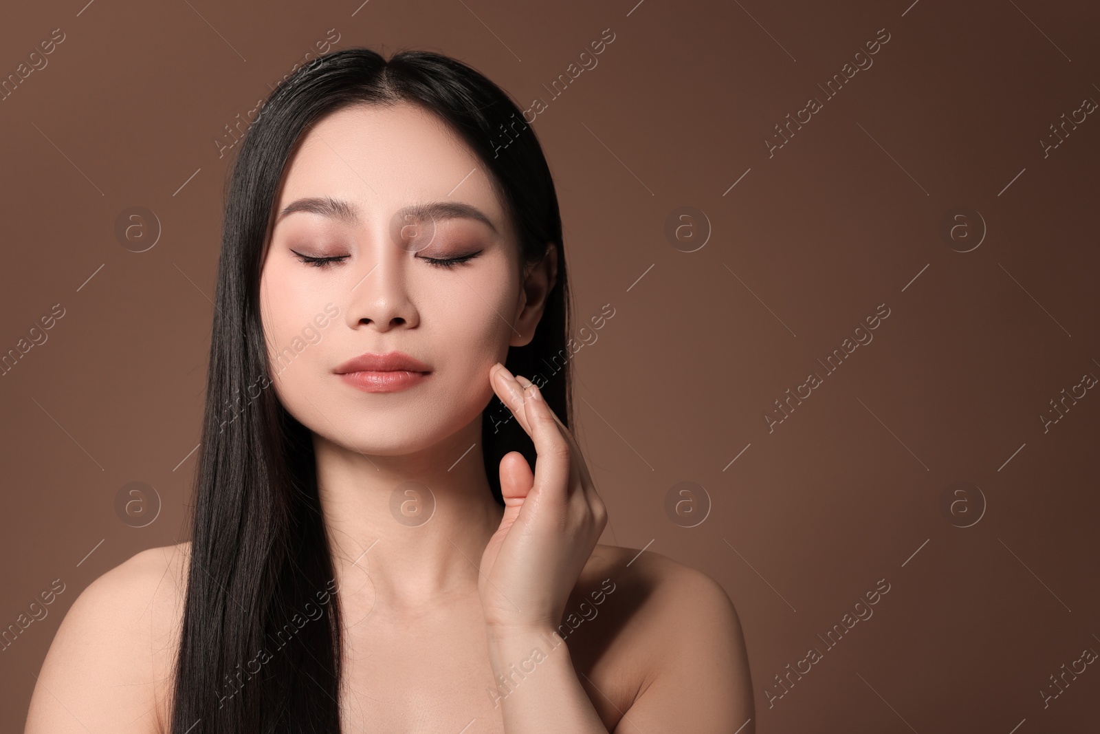 Photo of Portrait of beautiful woman on brown background, space for text