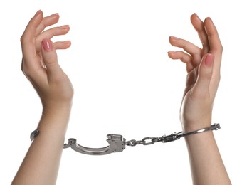 Photo of Freedom concept. Woman with handcuffs on white background, closeup