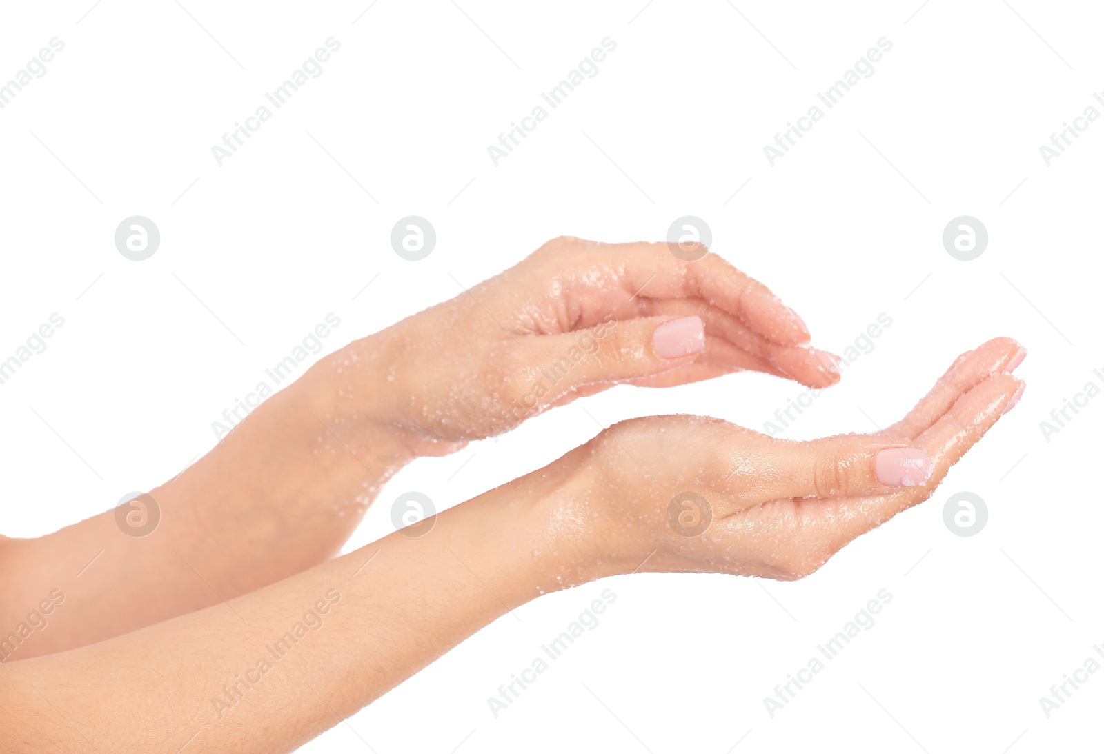 Photo of Young woman applying natural scrub on hands against white background