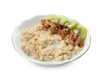 Photo of Bowl of quinoa porridge with walnuts, kiwi and milk on white background