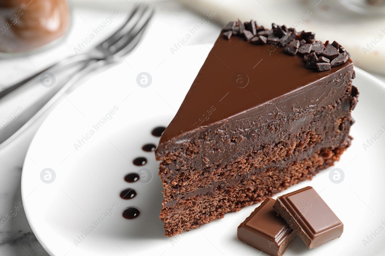 Photo of Delicious fresh chocolate cake served on white table, closeup