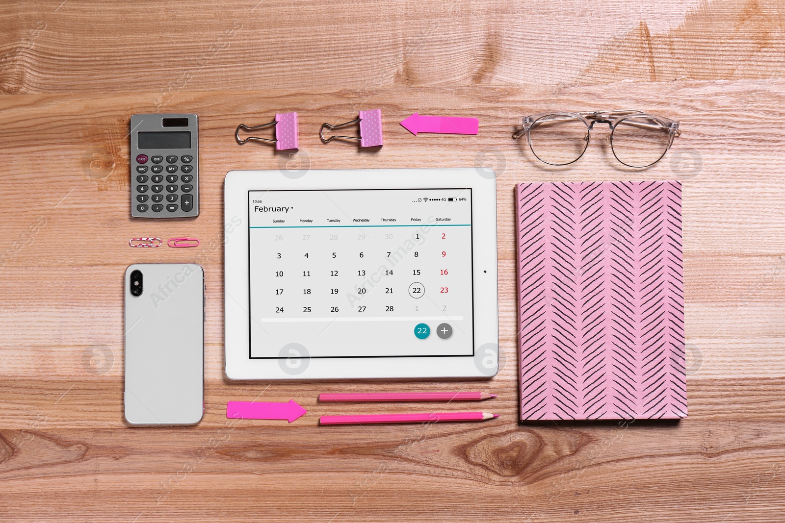 Photo of Flat lay composition of tablet with calendar app on wooden table